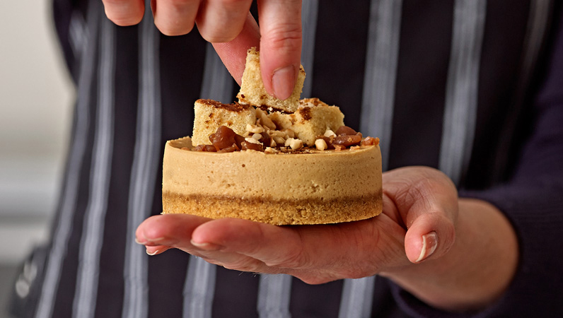 putting-topping-on-small-cheesecake_crop